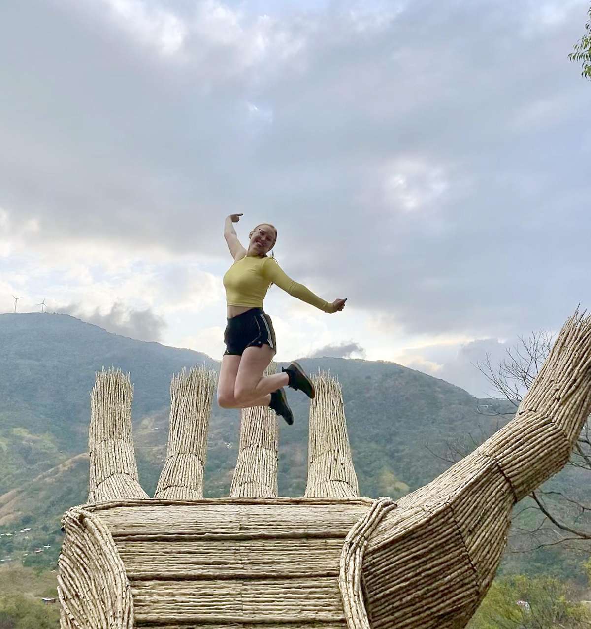 A study abroad student jumps into air for a tourist photo.