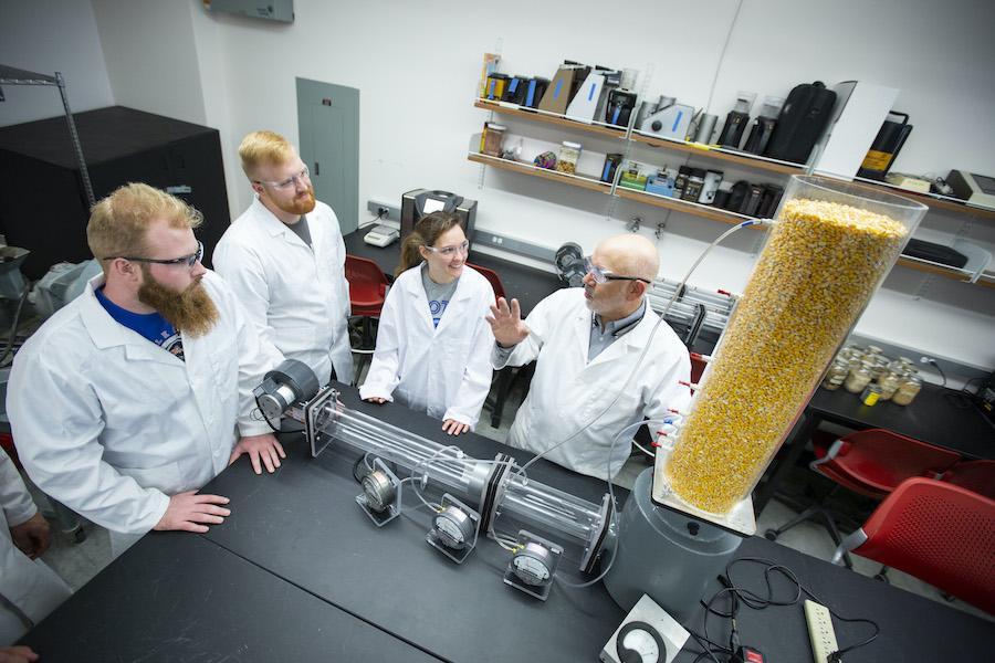 Tom Brumm and students in a lab