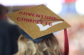 Mortarboard that says "Adventure Complete"